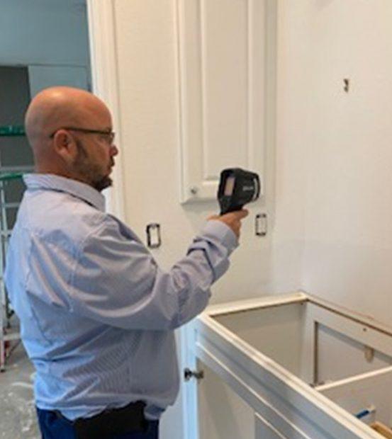 Mold Specialist performing mold inspection and testing in kitchen Tampa, FL